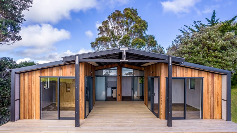 Architect designed modular home by Modular Dwellings with timber cladding and central covered outdoor living area